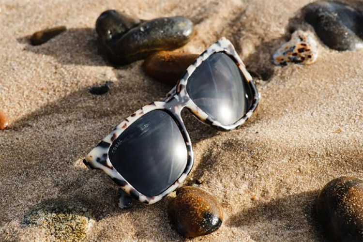 Sunglasses on beach sand from the new Nissan Formula E Team sponsor, sustainable fashion start-up Coral Eyewear