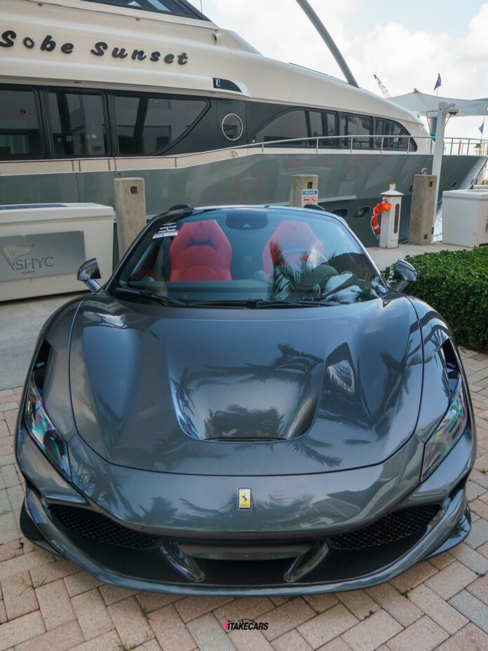 F8 with grey finish gleams in the sunlight, its red interior a bold contrast, as it settles into its Miami Beach spot at…